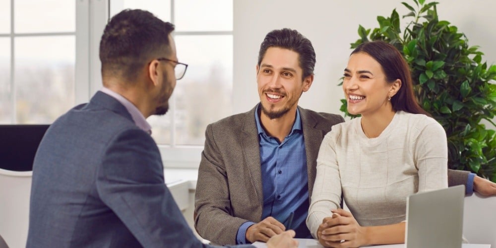 Happy couple meets with their advisor at the credit union.