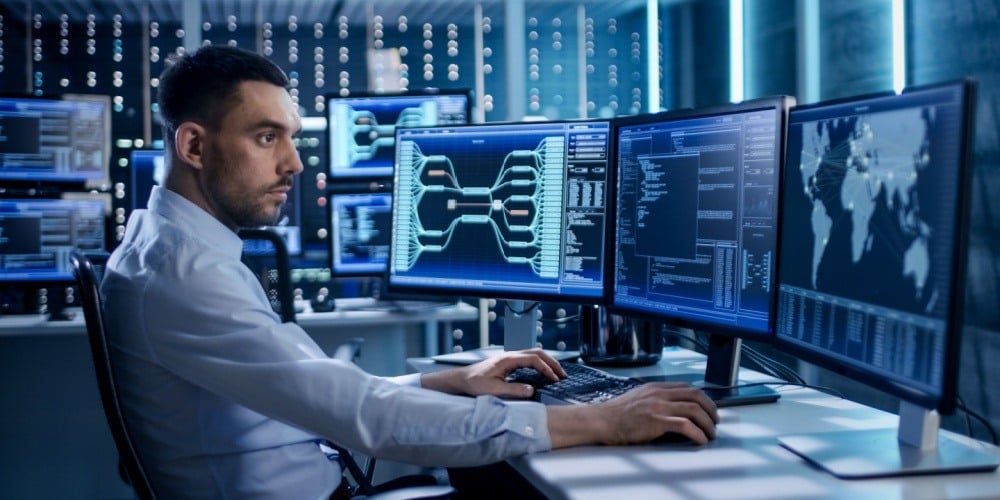 Male security specialist monitoring a screen.