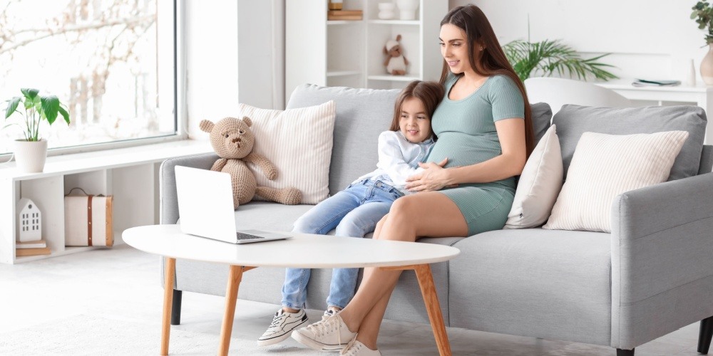 Woman and her daughter on a video call with someone.