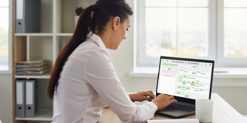 Woman scheduling appointments with an online appointment booking system. 