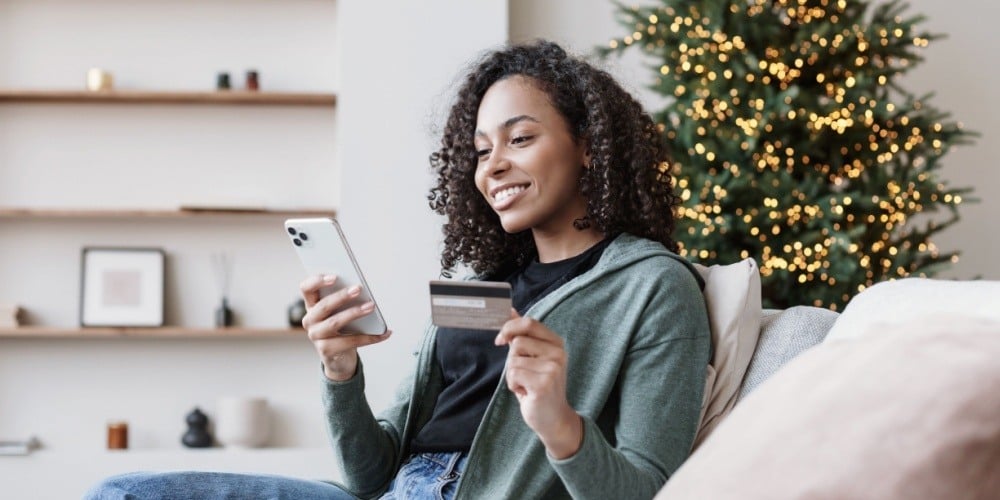 Woman holiday shopping on her phone. 