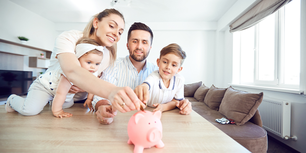 Family gathered around a piggy bank.